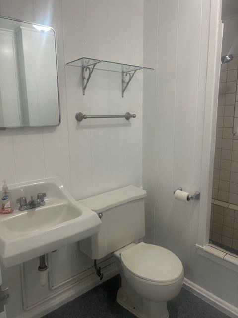a bathroom with a toilet sink and shower